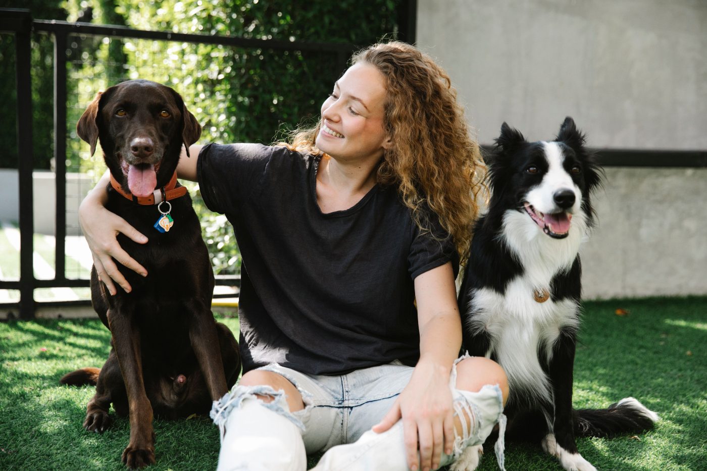 Member with her two dogs on the grass