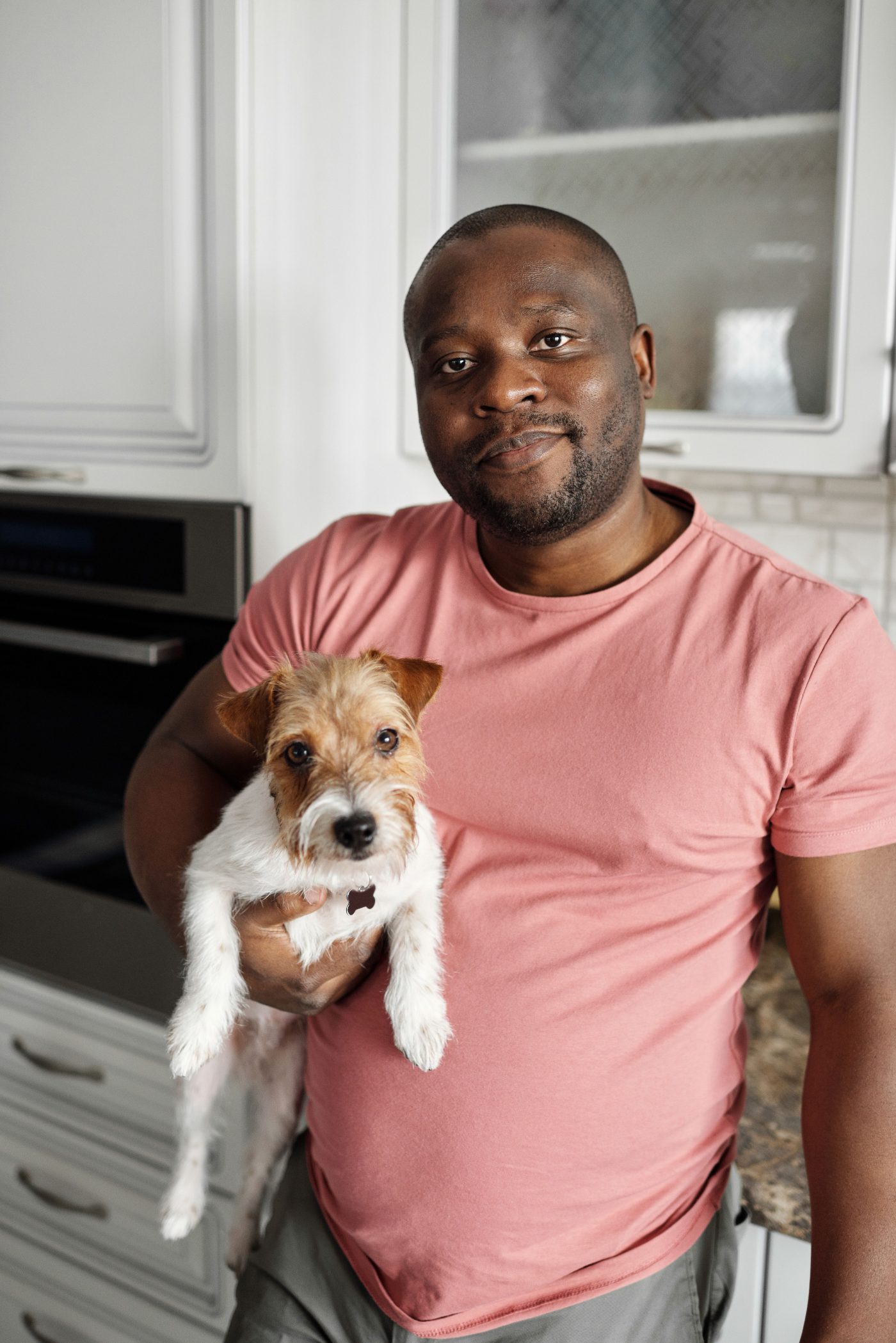 Member holding his terrier in the kitchen